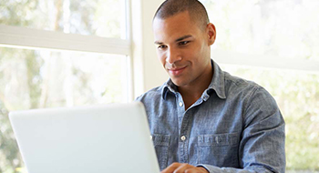 man looking at credit card offer on the computer